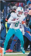  ?? MATT DURISKO/AP ?? Miami Dolphins safety Jevon Holland returns an intercepti­on during an NFL wild-card game Jan. 15 in Orchard Park, NY.