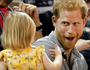  ??  ?? Cheeky! Prince Harry pulls faces at a toddler at the Invictus Games in Toronto yesterday