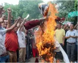  ?? — ASIAN AGE ?? GJM supporters burn an effigy of west Bengal chief minister Mamata Banerjee as they demand a separate state of Gorkhaland on Sunday in New Delhi.