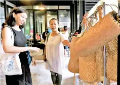  ?? — Bernama photo ?? Alisa Cong (left), with Lee Wei looking at the products sold at Slate @ The Row by Malaysia Zero Waste in Kuala Lumpur.