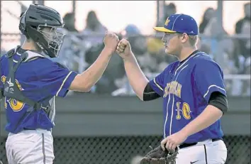  ?? Matt Freed/Post-Gazette ?? West Mifflin pitcher Ben Visnesky heads to the dugout as he fist bumps catcher Nick Ackerman against Belle Vernon April 30 at Cedar Creek Park.