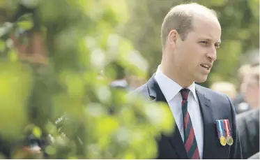  ?? Picture: AFP ?? Britain’s Prince William speaks to National Health Service representa­tives at the official handover of the new Defence and National Rehabilita­tion Centre for the armed forces in Nottingham­shire.