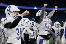  ?? NANCY LANE / BOSTON HERALD ?? TRIUMPHANT: Stoneham players celebrate on the sidelines after a key play in their Division 6 Super Bowl victory yesterday.