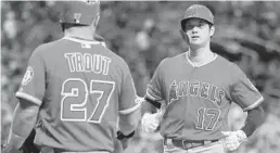  ?? MIKE CARLSON/GETTY ?? Shohei Ohtani gets a warm welcome from Mike Trout after homering Thursday.