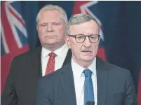  ?? FRANK GUNN THE CANADIAN PRESS FILE PHOTO ?? Premier Doug Ford listens as chief medical officer Dr. David Williams answers questions. Ford said he’s “not going to go against the medical profession­als” on Ontario’s reopening.
