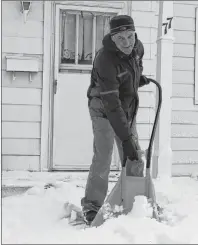  ?? KEIGAN MACLEOD/SPECIAL TO THE POST ?? Dave Poirier of Sydney was out clearing the snow off the front step of his house on Monday morning.