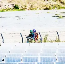  ?? PHOTOGRAPH BY YUMMIE DINGDING FOR THE DAILY TRIBUNE @tribunephl_yumi ?? A MOTORCYCLE rider speeds past a solar farm in Clark Freeport Zone, Mabalacat, Pampanga on Wednesday. With the threat of El Niño and escalating climate change, transition­ing to renewable energy has become imperative for the government to promote it in mitigating these challenges.