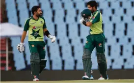  ??  ?? Pakistan's captain Babar Azam (right) celebrates after scoring a century as Mohammad Rizwan looks on