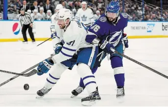  ?? CHRIS O’MEARA THE ASSOCIATED PRESS ?? Toronto Maple Leafs centre John Tavares, left, and Lightning winger Nikita Kucherov battle for the puck in Game 4 of their first-round playoff series Sunday in Tampa, Fla. The teams are tied at two wins apiece in the best-of-seven series. Tavares has yet to score a goal.