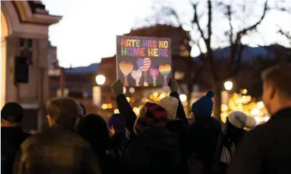  ?? Photograph: Alyson Mcclaran/Reuters ?? A person holds a sign during a vigil on 21 November at Acacia Park in Colorado Springs, Colorado, for the victims of the mass shooting at Club Q.