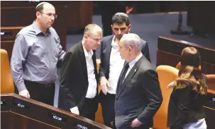  ?? (Marc Israel Sellem/The Jerusalem Post) ?? PRIME MINISTER Benjamin Netanyahu (right), stands in the Knesset plenum opposite Justice Minister Yariv Levin (second from left) and MK Simcha Rothman (far left), Constituti­on, Law and Justice Committee chairman, the two ringleader­s of the judicial overhaul legislatio­n, in December in Jerusalem.