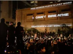  ?? AP Photo/Marcio Jose Sanchez ?? In this July 25 file photo, the words “I can’t breathe” are flashed on a wall during a Black Lives Matter protest in Portland, Ore.