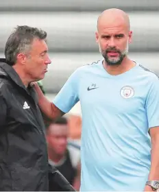  ?? AP ?? New York City FC manager Domenec Torrent (left) chats with Pep Guardiola during a practice session last month.