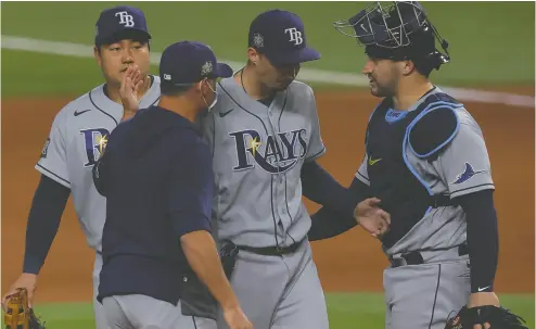  ?? RONALD MARTINEZ / GETTY IMAGES ?? Blake Snell, centre, of the Tampa Bay Rays is taken out of the game by manager Kevin Cash in the sixth inning of the deciding game of last year’s World Series, in what Scott Stinson writes was one of the big controvers­ies of the contest.