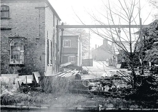  ??  ?? Sent in by Looking Back reader Mike Jones, this photo is taken from the edge of the canal at the bottom of the other Z. Onions entrance, closer to the Rushes, looking up at the houses on Regent Street, Loughborou­gh that were demolished in the 1960s and...
