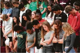  ?? Melissa Phillip / Staff photograph­er ?? People pray for Jordyn Hawkins, an Austin High School student, in Sugar Land. The 15-year-old suffered a spinal cord injury and is undergoing treatment.