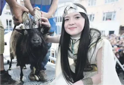  ?? Picture: Reuters ?? JUST THE TWO OF US. Puck Queen Caitlin Horgan, 12, with the newly crowned King Puck goat in Killorglin, Ireland.