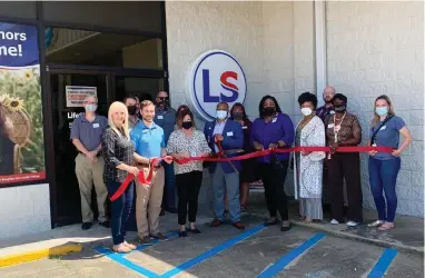  ?? (Contribute­d) ?? Above, from left, front row: Dianne Hammond, Jaren Books, Karen Thomas, Brandon Baker (cutting ribbon), Kourtney Washington, Mayor Veronica Smith-Creer, Janice Hicks and Joanna Benson. Back row, from left, Michael O’Connell, Doug Stanton, Byron Winn, Steve Biernacki, Alexis Alexander and Justin Howard.