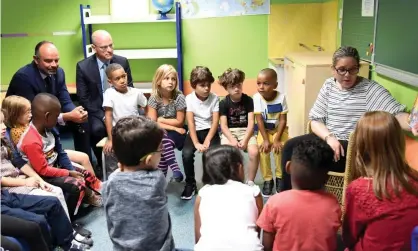  ??  ?? Pupils in France last September on their first day of the school year, sitting alongside the French prime minister, Édouard Philippe (left) and beside him the education minister, Jean-Michel Blanquer. Photograph: Bertrand Guay/AFP/Getty Images