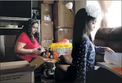  ?? Katie Falkenberg Los Angeles Times ?? CRISTINA MORAN packs up the one-bedroom apartment she lives in with her husband and two daughters, Kimberly, 20, and 5-year-old Jaylin, right.