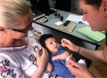  ?? AP Photo/Olimpiu Gheorghiu ?? ■ A child gets a dose of vaccine Wednesday in Chitila, Romania. An outbreak of measles has killed dozens of infants and children in Romania, with 200 new cases reported each week. Doctors say the surge in the disease is aided by low rates of...