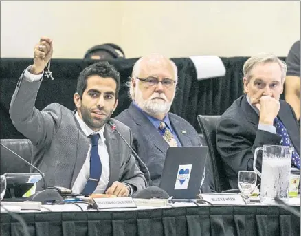  ?? Damian Dovarganes Associated Press ?? UC FACULTY members were divided over naming anti- Zionism as an expression of anti- Semitism. Above, UC student regent Abraham Oved, left, holds up a Star of David as he addresses regents during a meeting last year on a policy statement on intoleranc­e.