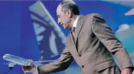  ??  ?? Qatar Airways Chief Executive Akbar Al Baker holds a scale model of a Qatar Airways Airbus A350-1000 during a news conference in Blagnac near Toulouse, France, February 20, 2018.