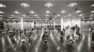  ?? LM Otero / Associated Press ?? People who received vaccine shots sit socially distanced as they wait the required 15 minutes to monitor for adverse reactions at the Dallas County mass vaccinatio­n site at Fair Park.