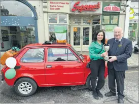  ?? Ó Lochlainn) (Photo: Donal ?? Aneta Hytros and her cute Fiat Bambino, being presented with a special award at the Fermoy St Patrick’s Day parade by chairman, John Murphy.