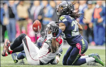  ?? OTTO GREULE JR / GETTY IMAGES ?? Seahawks cornerback Richard Sherman could have been called for pass interferen­ce against Julio Jones when the teams played in October.