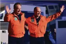  ?? Ahmed Kutty/Gulf News ?? From left: Andre Borschberg and Bertrand Piccard greet supporters after completing their round-the-world flight with Solar Impulse 2 in Abu Dhabi on Tuesday.