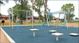  ??  ?? Left: There is something for everyone, young to old, at the newly equipped playground in Fort Oglethorpe. Above: The new playground features a separate area where adults can work out with trapeze rings, a sit-up bench, parallel bars and other equipment.