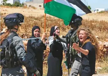  ?? AFP ?? ■ Ahed Tamimi (right) confronts Israeli forces during a demonstrat­ion on May 26, 2017, in the village of Nabi Saleh, north of Ramallah, in the Israeli-occupied West Bank.