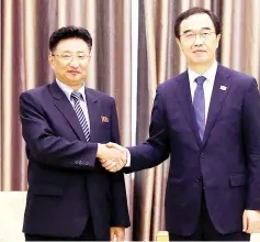  ??  ?? Won shakes hands with Cho during their meeting in Pyongyang, North Korea. — Reuters photos