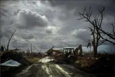  ?? Ramon Espinosa/Associated Press ?? Mos Antenor clears a road with a bulldozer Friday on Grand Bahama Island as Hurricane Dorian cleanup continues.