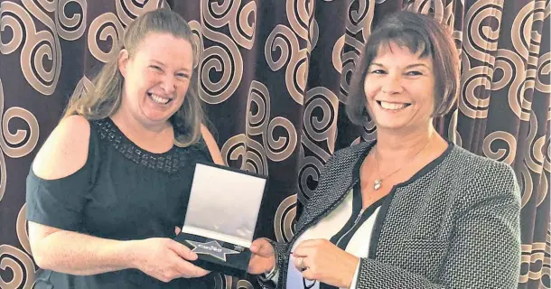  ??  ?? YOU’RE THE TOPS: Valerie Maxwell, right, centre director at Dee View Court, presents Donna Lovie, whom she described as inspiratio­nal, with her award