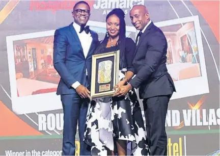  ?? PHOTO BY ASHLEY ANGUIN ?? The Gleaner’s editor-in-chief, Kaymar Jordan, presents the RJRGLEANER Hospitalit­y Jamaica 2019 Best Boutique Resort award to Round Hill Hotel and Villas’ Omar Robinson (right) and Calvin Lewis.