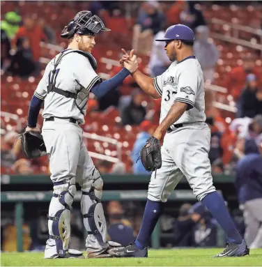  ?? ASSOCIATED PRESS ?? Milwaukee Brewers catcher Jett Bandy congratula­tes closer Neftali Feliz after a victory over the St. Louis Cardinals last week.