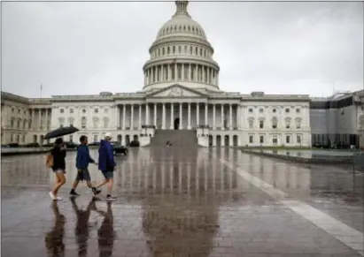  ?? J. SCOTT APPLEWHITE — THE ASSOCIATED PRESS ?? The Capitol is seen during a heavy rain as lawmakers begin their August recess, in Washington, Friday.