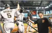  ?? JENNIFER STEWART — GETTY IMAGES ?? The Giants’ Denard Span is congratula­ted by Nick Hundley and manager Bruce Bochy after scoring in the third inning.