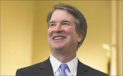  ?? Alex Edelman / Getty Images ?? Judge Brett Kavanaugh smiles during a visit to the Russell Senate Office Building in Washington, D. C., on Thursday.