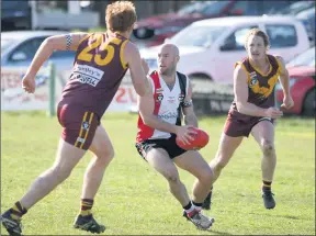  ??  ?? ON THE MOVE: Horsham Saints coach Luke Fisher prepares to elude Warrack Eagle Jacob Cheney during Wimmera Football League action at Coughlin Park. Picture: PAUL CARRACHER