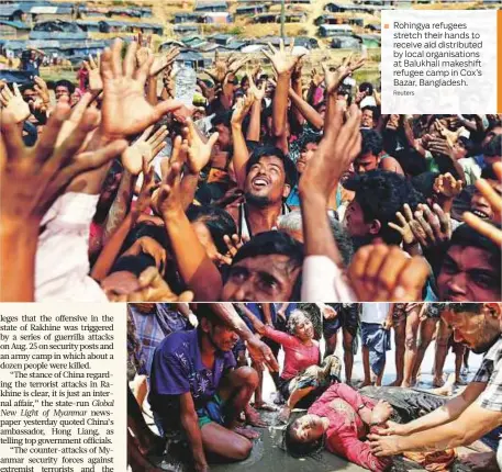  ?? Reuters ?? Rohingya refugees stretch their hands to receive aid distribute­d by local organisati­ons at Balukhali makeshift refugee camp in Cox’s Bazar, Bangladesh.