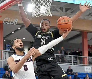  ?? Matt Freed/Post-Gazette ?? Robert Morris’ Josh Williams attempts a reverse layup against Bryant’s Hall Elisias.