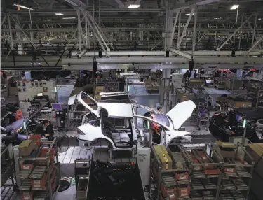  ?? Lea Suzuki / The Chronicle 2018 ?? A Model X moves down the line at Tesla’s Fremont factory in 2018. The manufactur­er of electric cars delivered 90,650 cars in the second quarter, down just 5% from a year earlier.