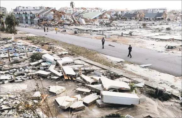  ?? Gerald Herbert / Associated Press ?? Rescue personnel on Thursday search amidst debris in the aftermath of Hurricane Michael in Mexico Beach, Fla.