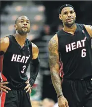  ?? GETTY IMAGES FILE ?? Reports in Chicago and Cleveland say current Bulls guard Dwyane Wade (left) and LeBron James, pictured as Miami Heat teammates, could be reunited with the Cleveland Cavaliers during the upcoming NBA season.