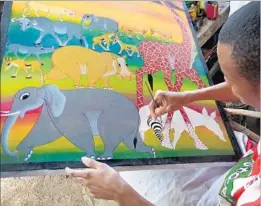  ?? Photograph­s by John Muncie ?? HASIN WHITE paints in Tinga Tinga style at a shop near Tarangire park.