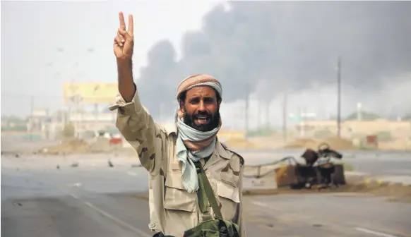  ?? EPA ?? A member of Yemen’s government forces in celebrator­y mood during battles against Houthi rebels in the port city of Hodeidah this week