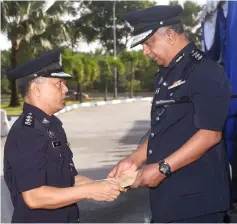  ??  ?? KLIA District Police chief ACP Zulkifli Adamsah (right), hand over special award to Assistant Police officer of Malaysia Airport Bhd ASP Nazri Ishak.